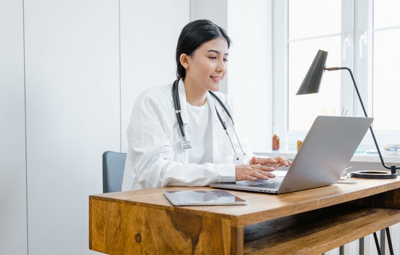 A healthcare worker at their desk