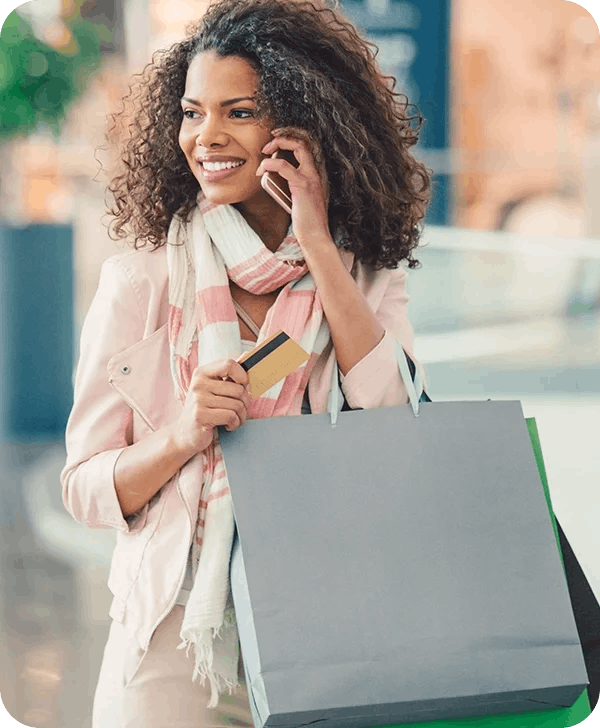 a woman with a shopping bag on her phone